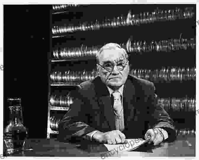 A Black And White Photograph Of John Grierson, A Man With A Receding Hairline And Spectacles, Wearing A Suit And Tie, Working At A Desk. John Grierson (Quest Biography 14)