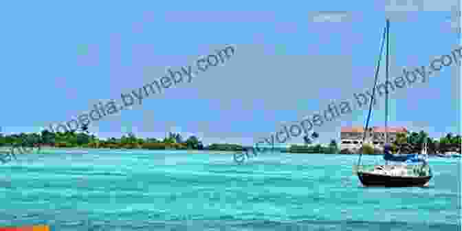 A Traditional Wooden Sailboat Sails Through The Turquoise Waters Of Belize, With The Belize Barrier Reef In The Background Island Time: Adventures Of A Traditional Wooden Sailboat In Belize